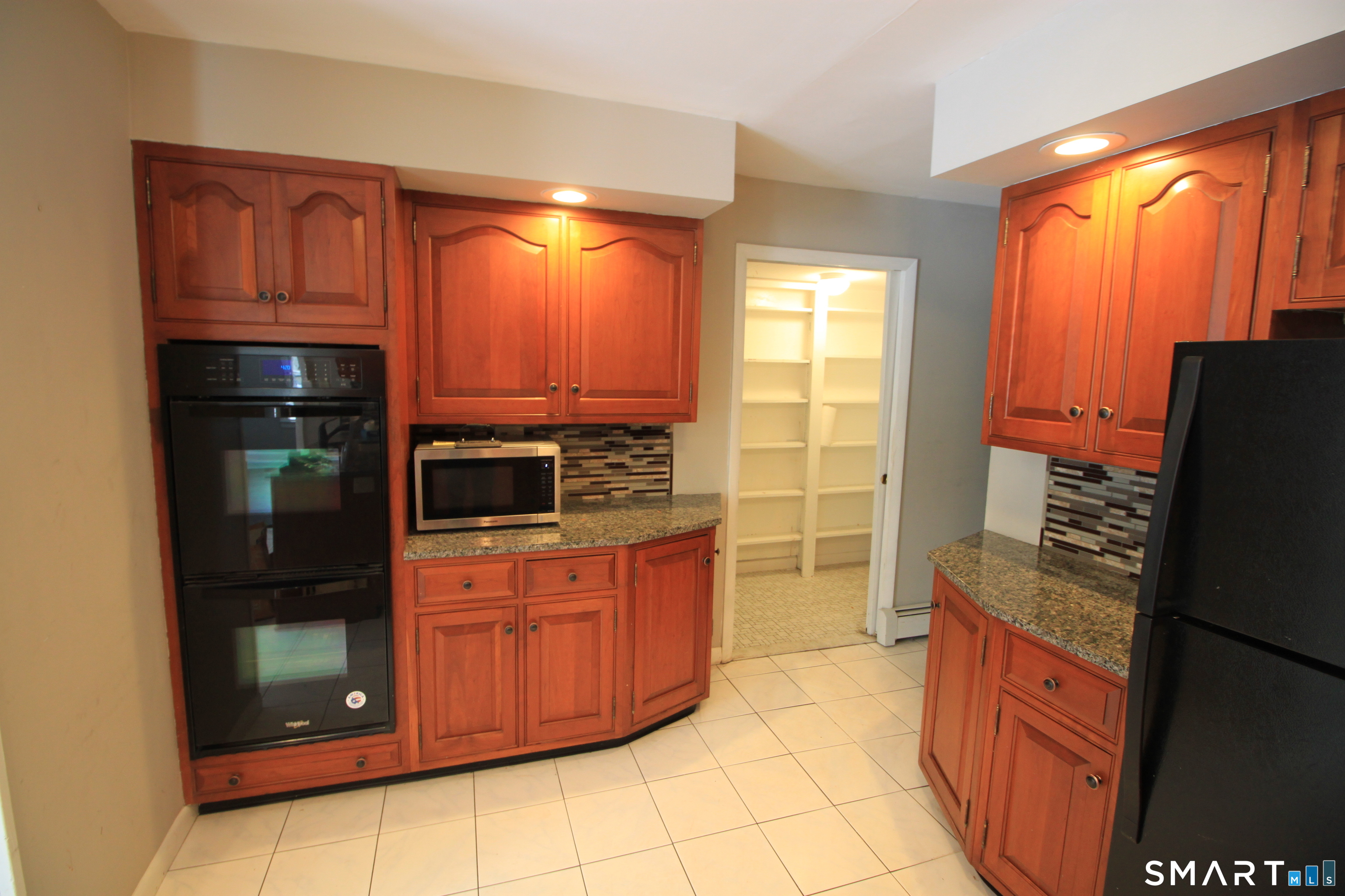 11 Old Fairwood Road Bethany, CT 06524 - Photo 7 of 20 a kitchen with stainless steel appliances a stove a refrigerator and a sink