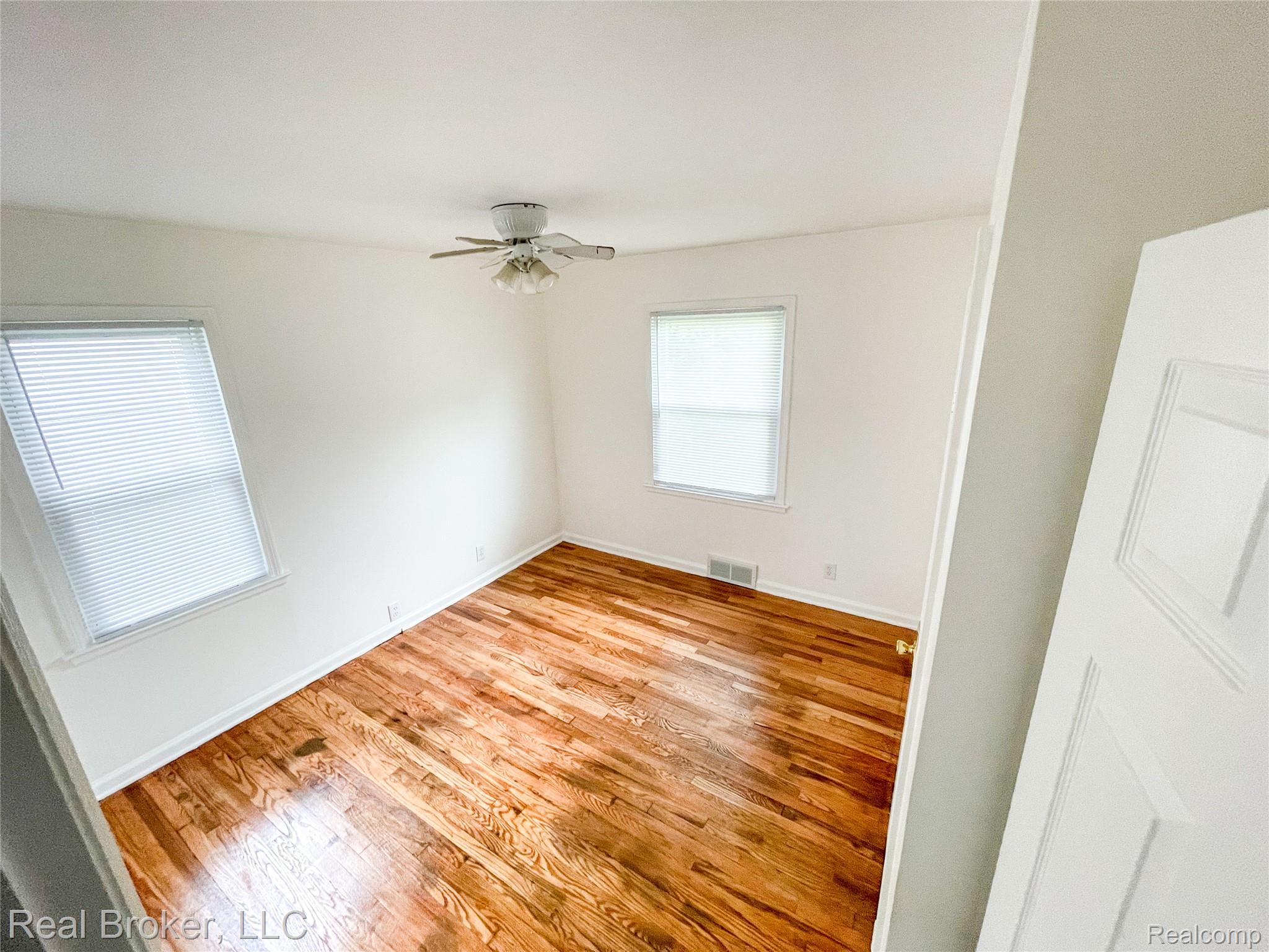 603 Vernier Road Grosse Pointe, MI 48236 - Photo 7 of 33 Unfurnished room with light wood-style floors and a ceiling fan