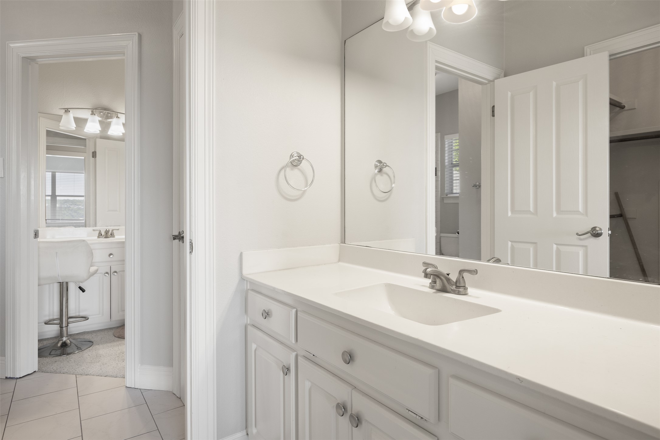 9300 Simmons Road Austin, TX 78759 - Photo 12 of 17 A well-lit bathroom vanity with a spacious counter and ample storage below the sink.