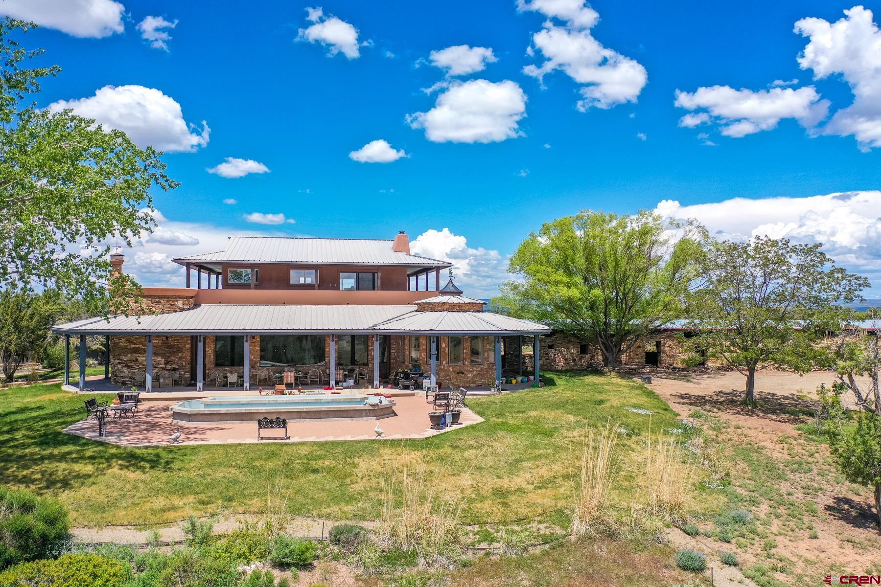 22023 Rd K Cortez, CO 81321 - Photo 1 of 35 a view of a house with swimming pool and porch with furniture