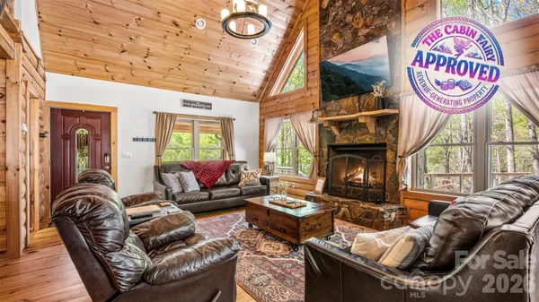 a living room with furniture a fireplace and a table