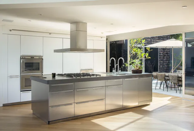 a kitchen with stainless steel appliances granite countertop a stove and a refrigerator