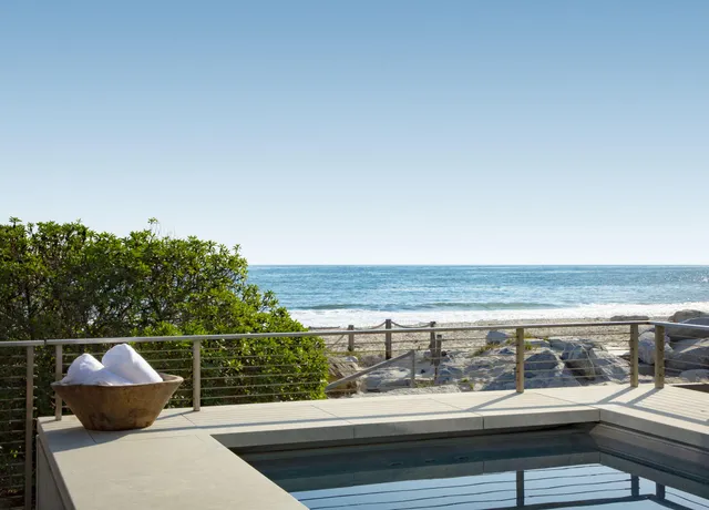a view of roof deck with wooden floor and fence