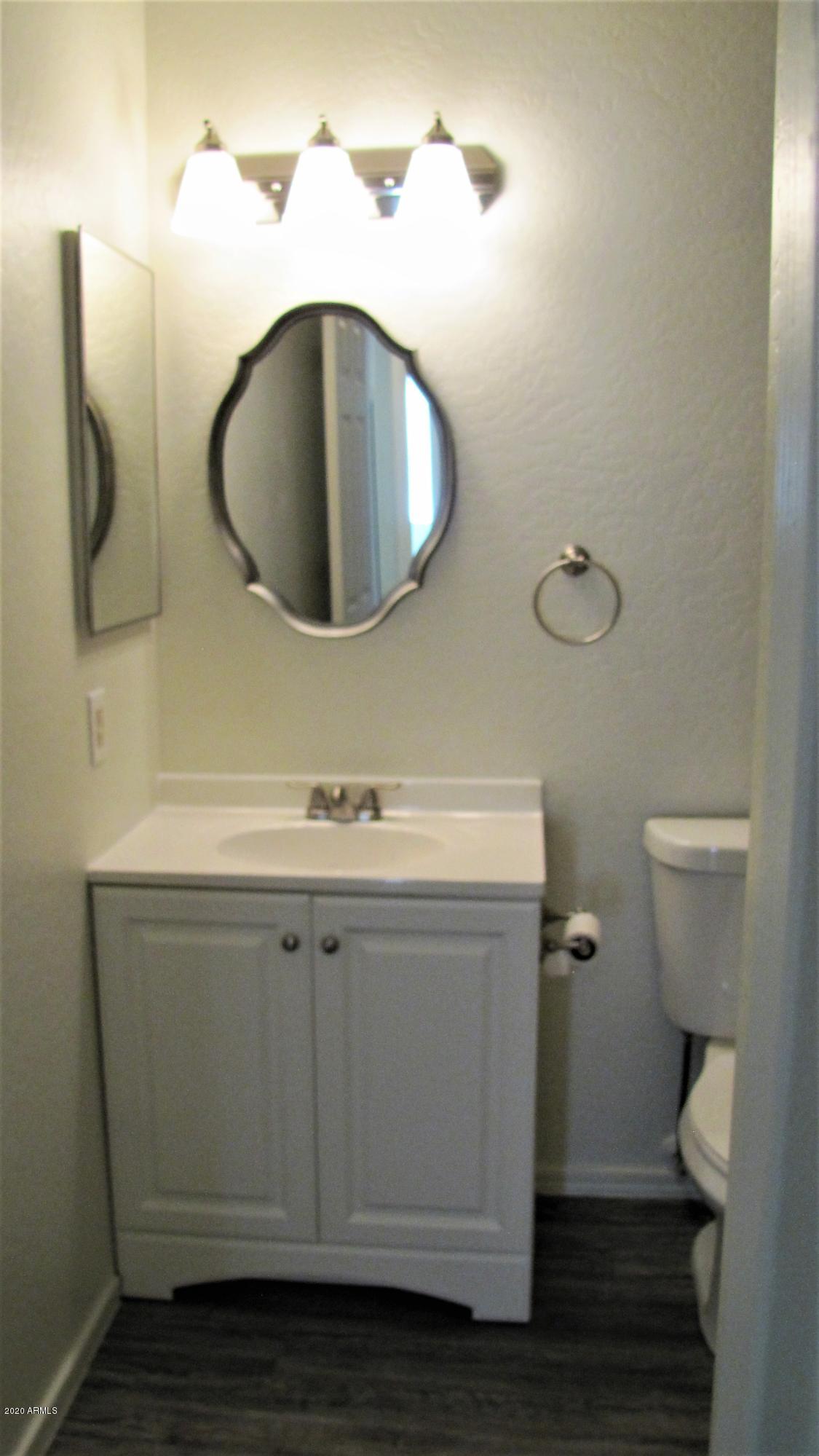 16086 West Calavar Road Surprise, AZ 85379 - Photo 15 of 28 a bathroom with a sink and a mirror