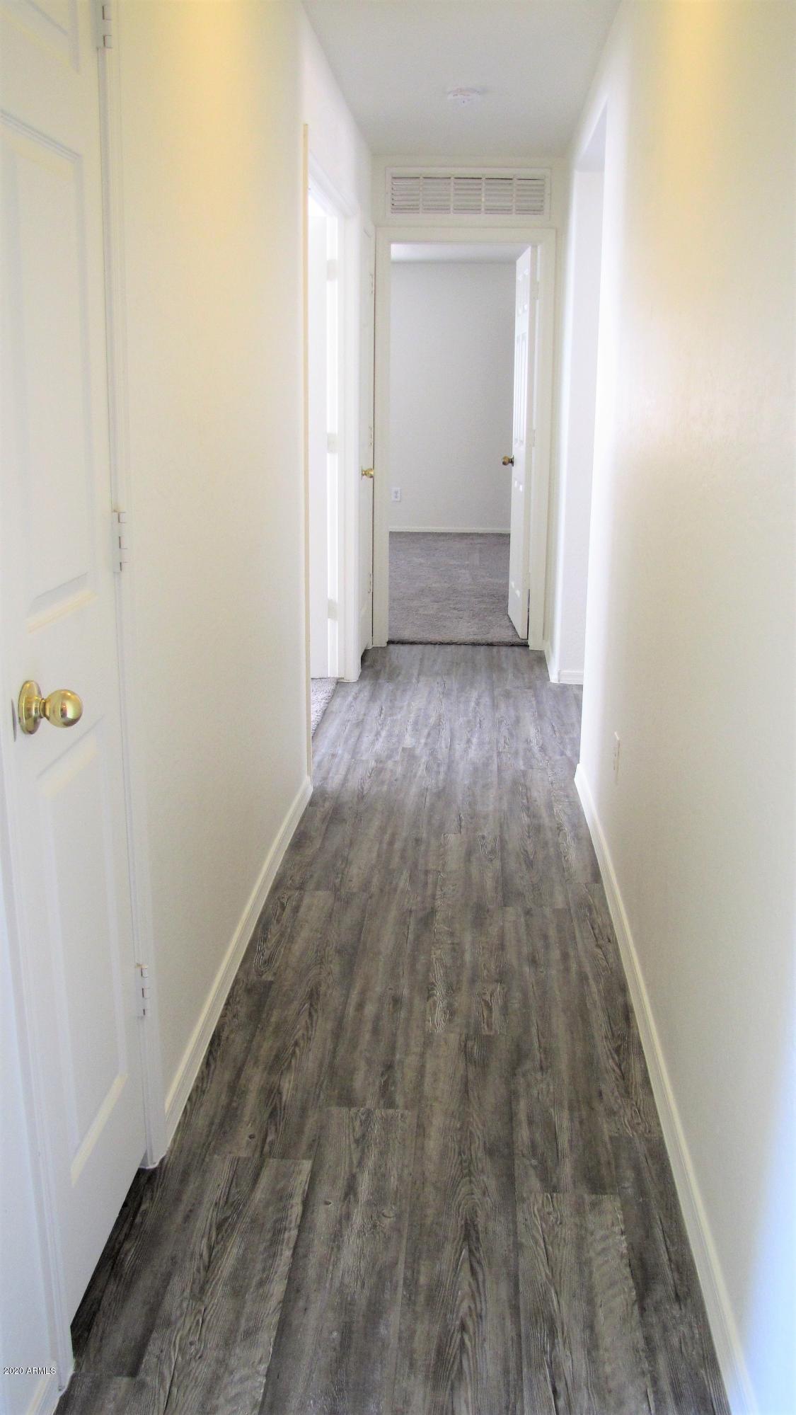 16086 West Calavar Road Surprise, AZ 85379 - Photo 16 of 28 a view of a room with wooden floor