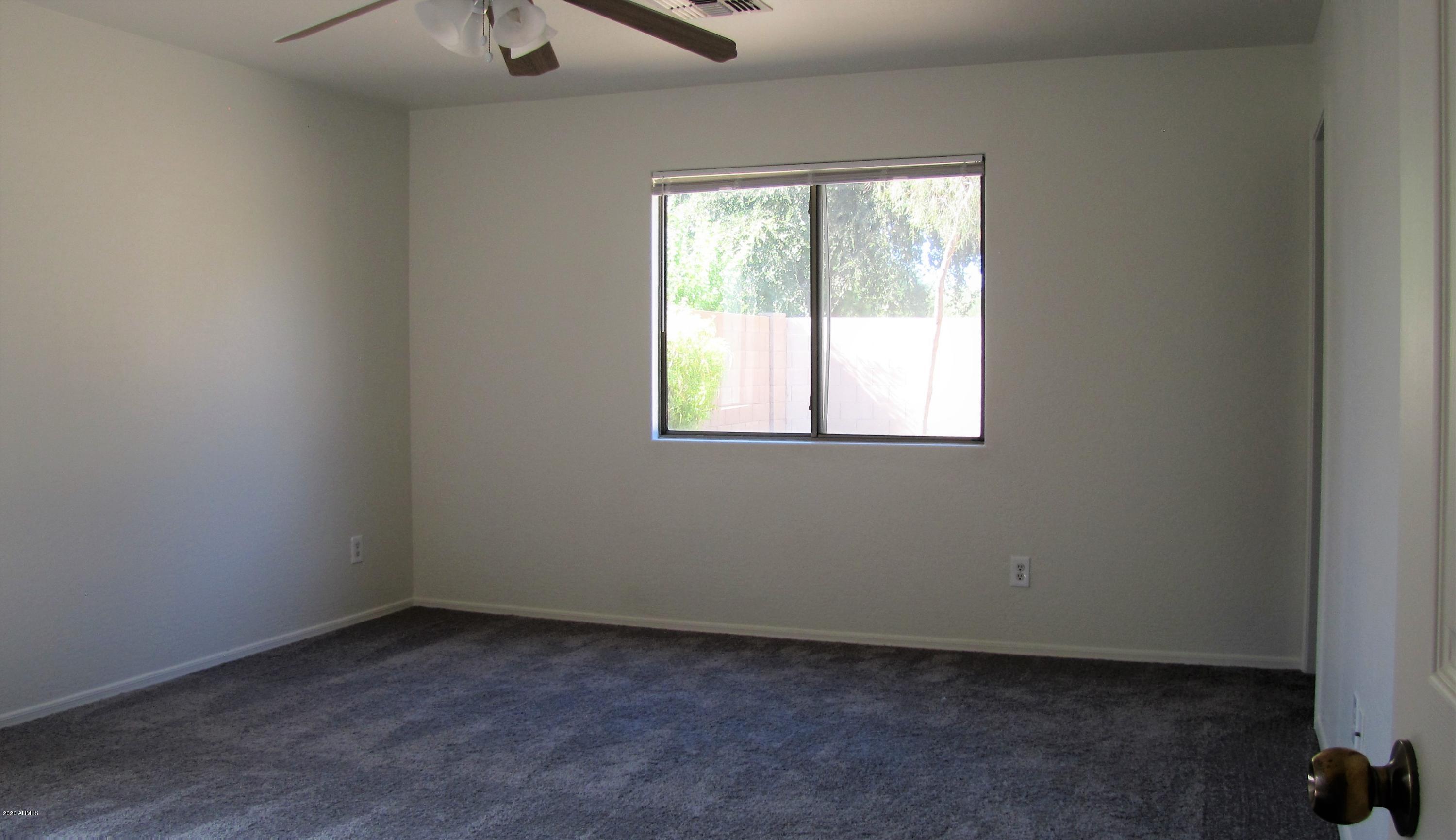 16086 West Calavar Road Surprise, AZ 85379 - Photo 18 of 28 an empty room with a window