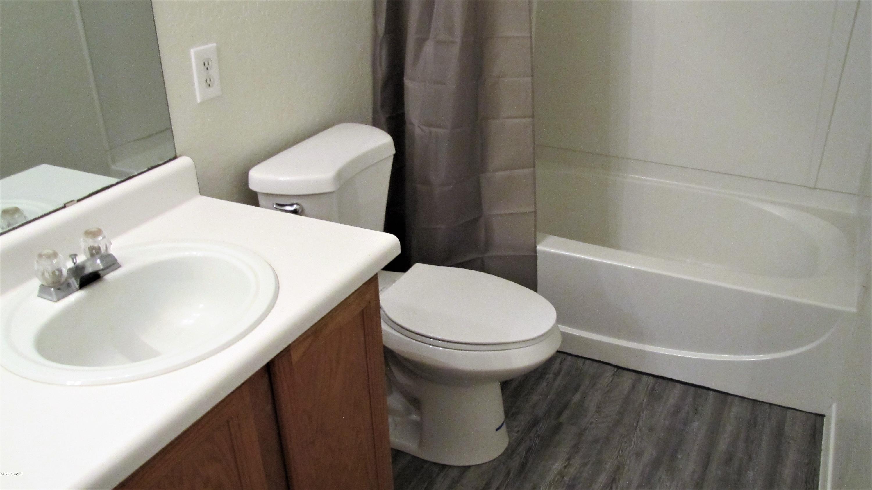 16086 West Calavar Road Surprise, AZ 85379 - Photo 20 of 28 a white toilet sitting next to a bathroom sink