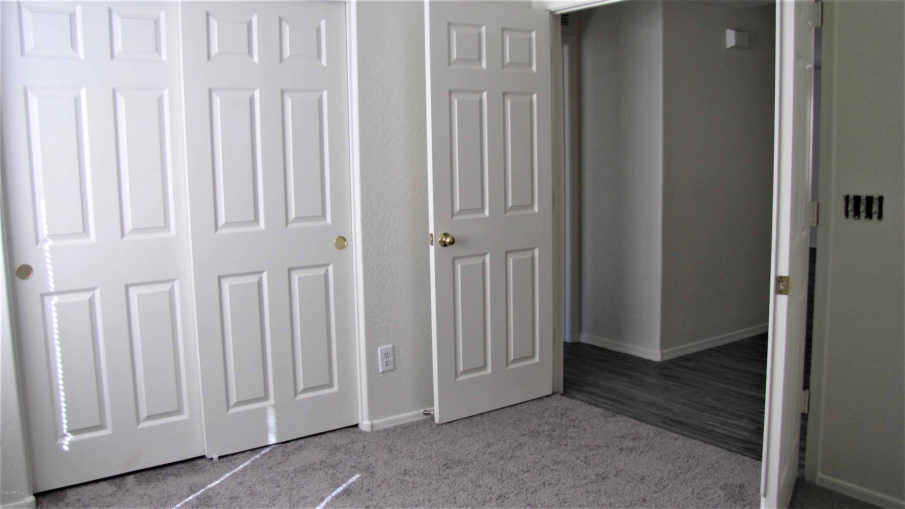 16086 West Calavar Road Surprise, AZ 85379 - Photo 21 of 28 an empty room with a door