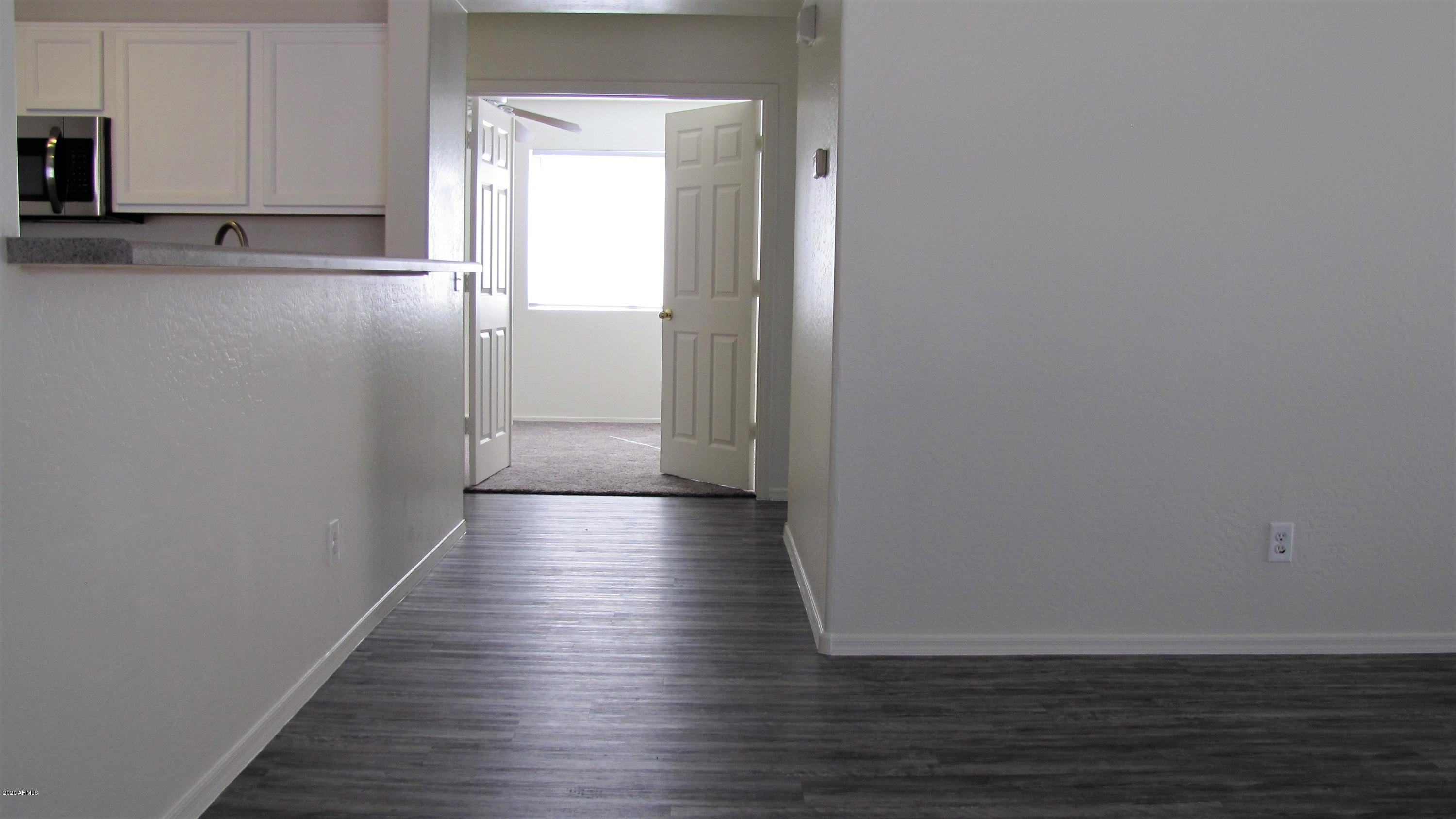 16086 West Calavar Road Surprise, AZ 85379 - Photo 5 of 28 a view of a hallway with wooden floor