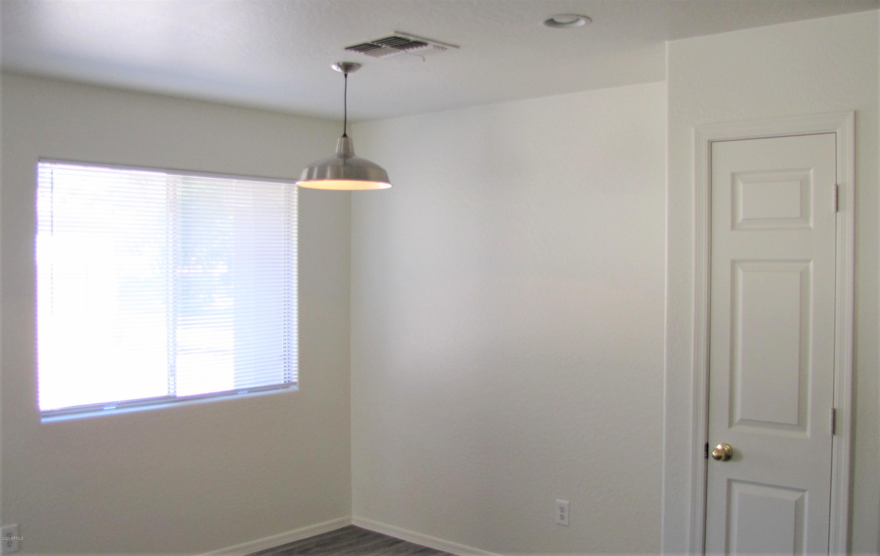 16086 West Calavar Road Surprise, AZ 85379 - Photo 9 of 28 a room with a window and a glass door