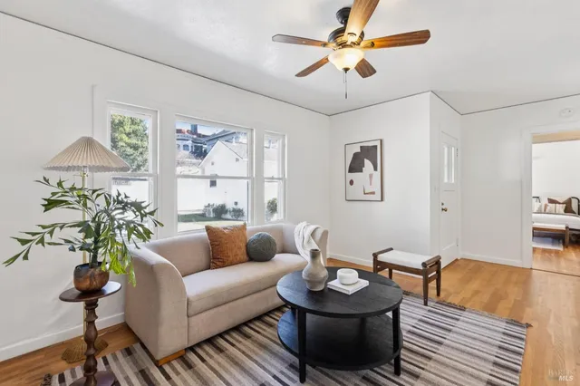 a living room with furniture a chandelier and a window