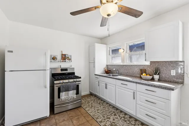 a kitchen with a stove cabinets and refrigerator