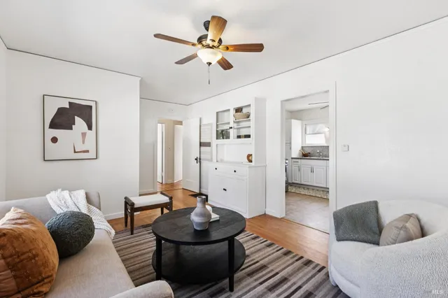 a living room with furniture and a view of bathroom