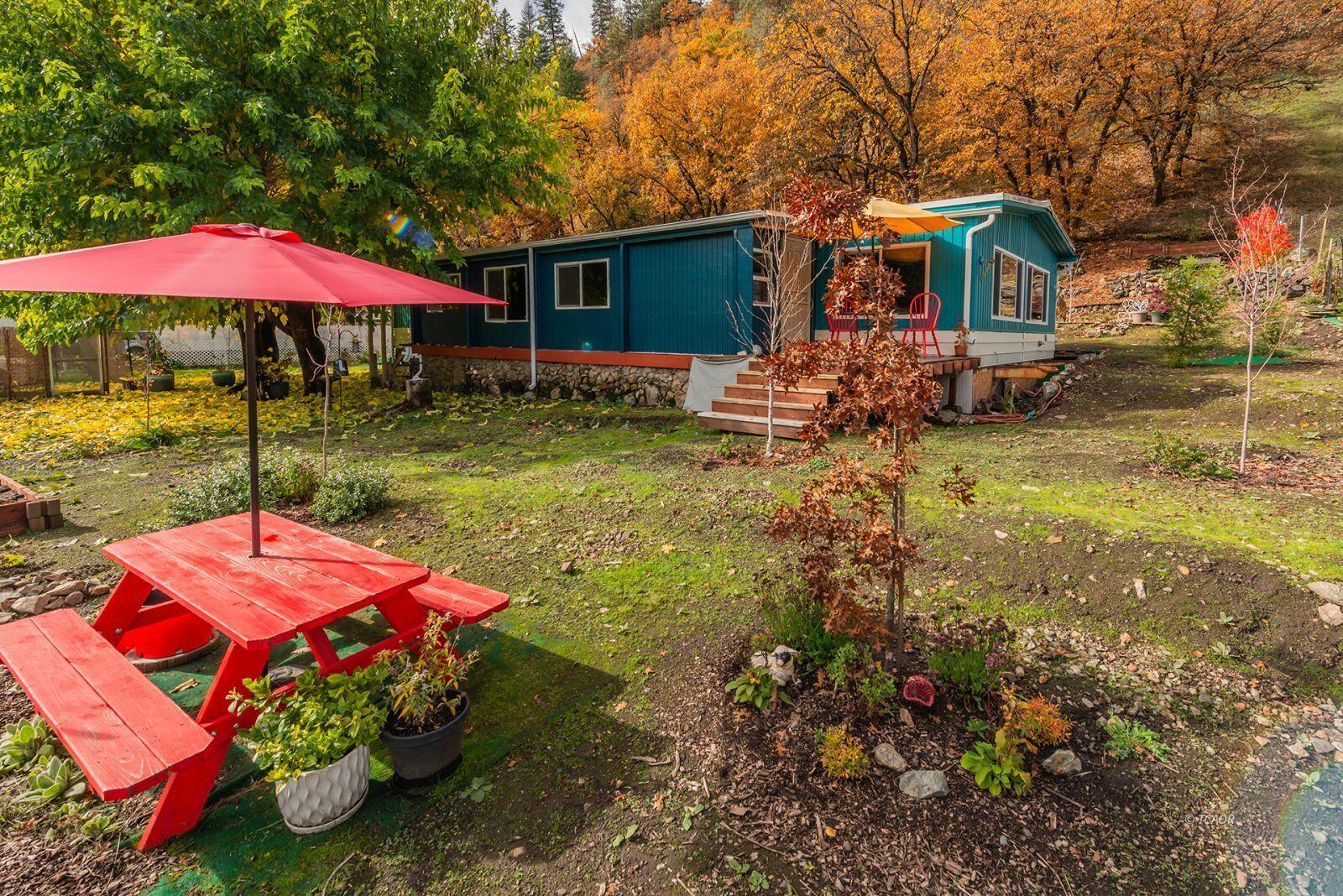 a view of a house with backyard and sitting area