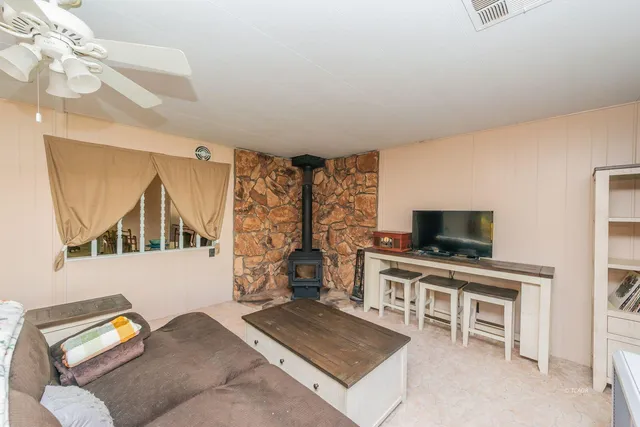 a kitchen with sink a refrigerator and chairs