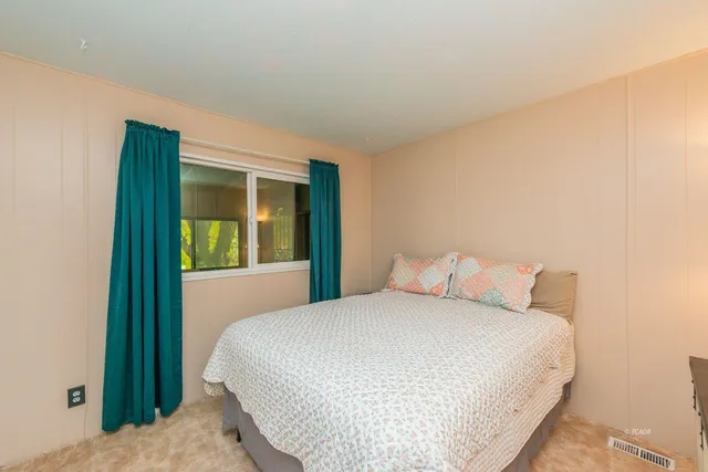 a bedroom with a bed and a lamp