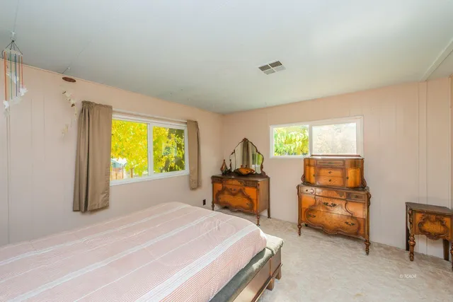 a bedroom with a large bed and a large closet