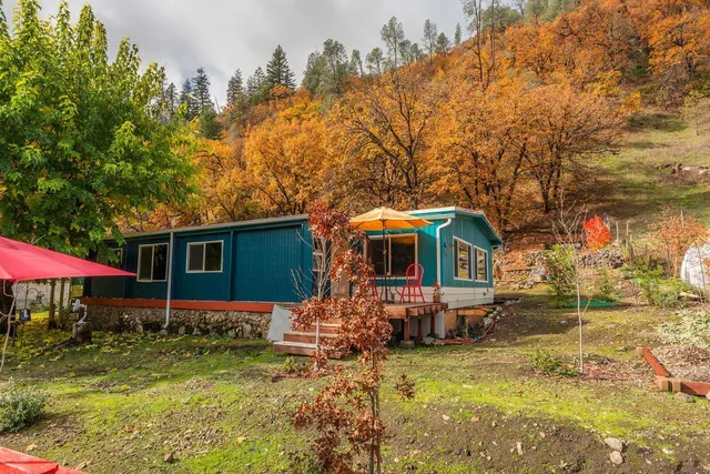 a backyard of a house with barbeque oven table and chairs