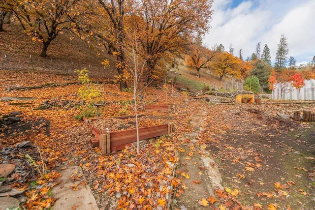 a backyard of a house with table and chairs