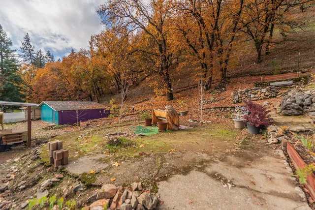 a backyard of a house with table and chairs