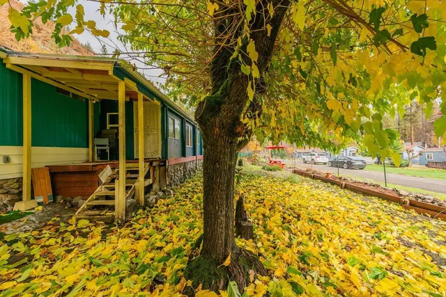 a backyard of a house with barbeque oven table and chairs