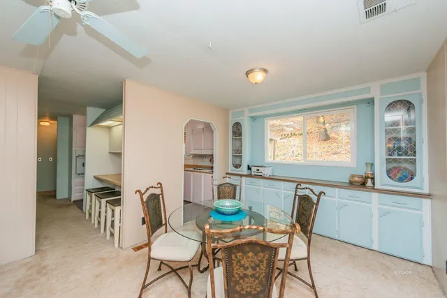 a view of a dining room with furniture and window