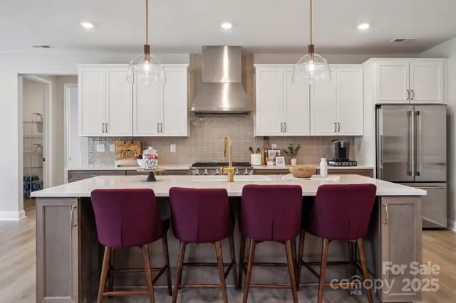 a large kitchen with a table and chairs