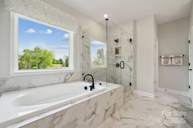 a living room with furniture a flat screen tv and a large window