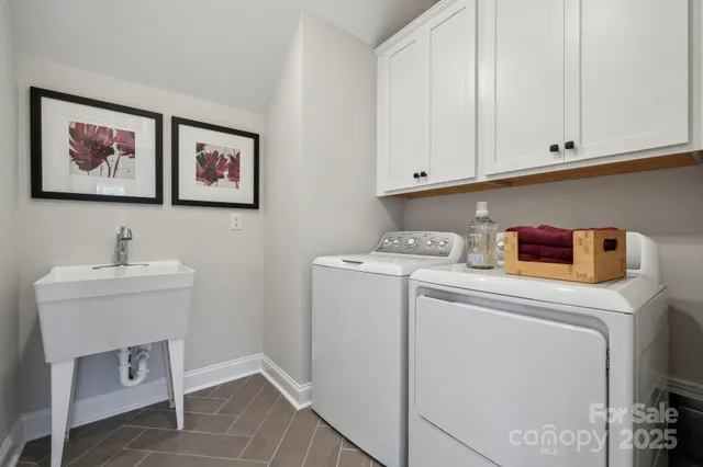 a bathroom with a double vanity sink a toilet and shower