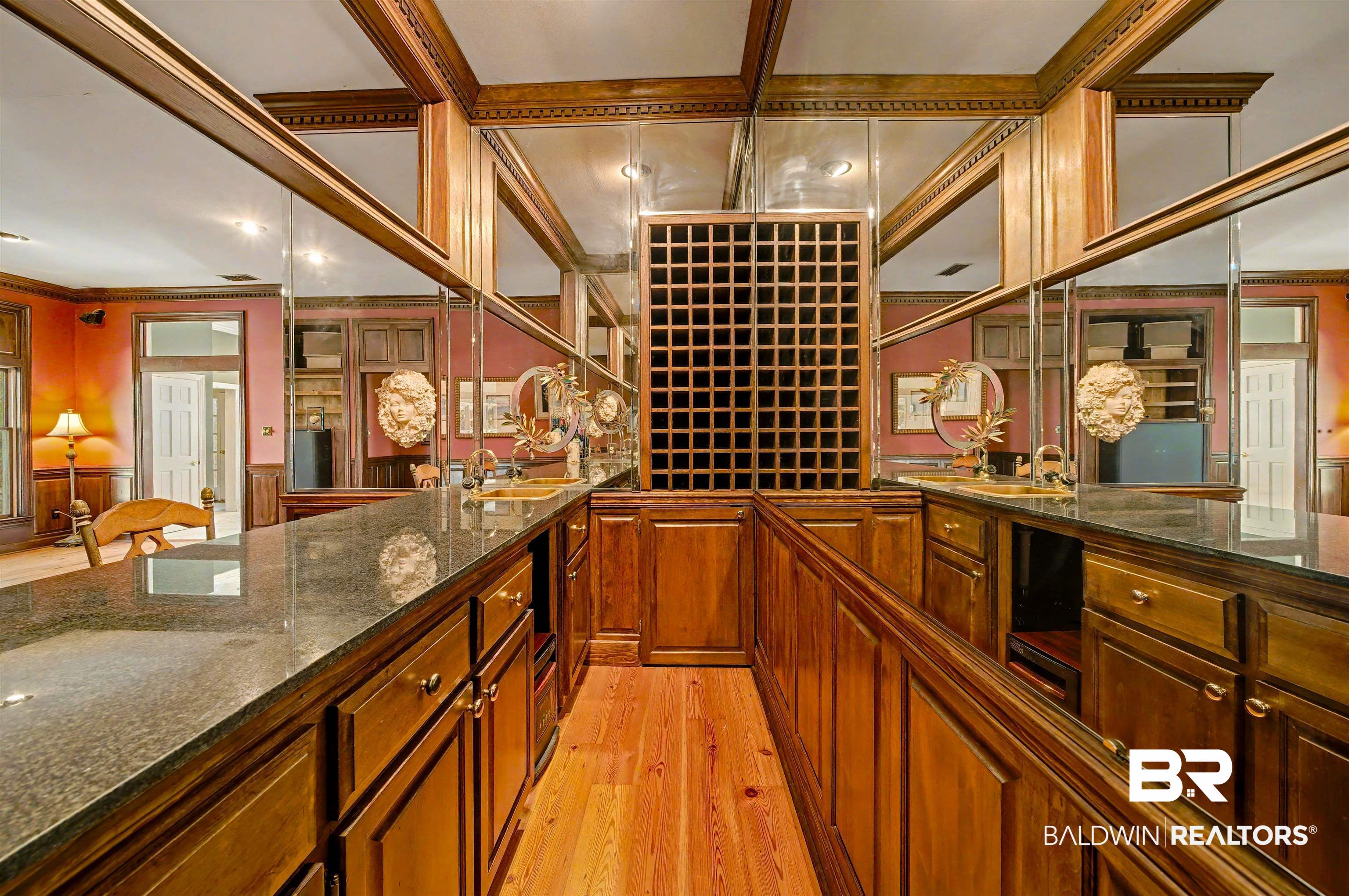 15810 County Road 73 Foley, AL 36535 - Photo 43 of 56 Wine cellar featuring light wood finished floors, ornamental molding, and a wainscoted wall