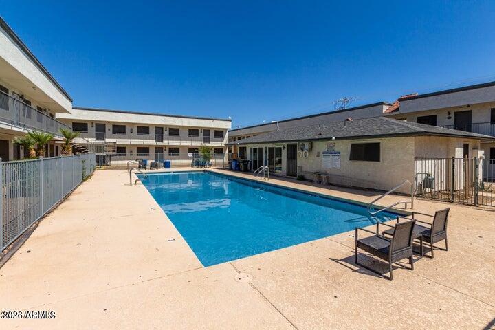 a view of a swimming pool with chairs