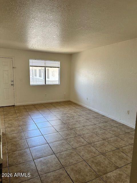 18202 North Cave Creek Road, Unit 212 Phoenix, AZ 85032 - Photo 4 of 12 an empty room with windows