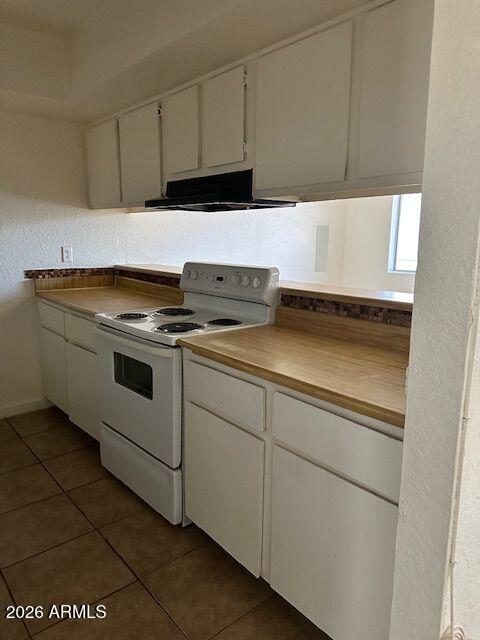 18202 North Cave Creek Road, Unit 212 Phoenix, AZ 85032 - Photo 9 of 12 a stove top oven sitting inside of a kitchen