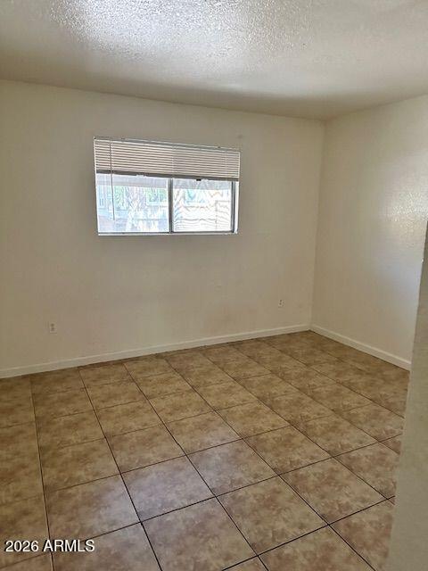 18202 North Cave Creek Road, Unit 212 Phoenix, AZ 85032 - Photo 10 of 12 an empty room with windows