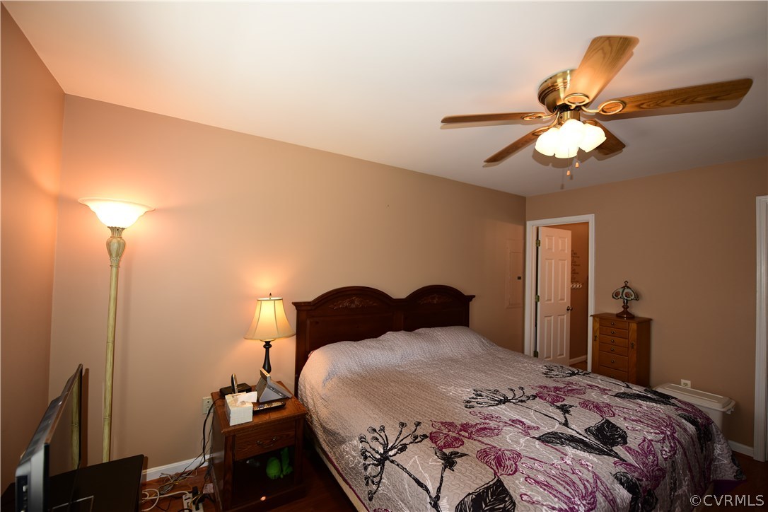 20820 Beaver Dam Road Beaverdam, VA 23015 - Photo 8 of 26 a bedroom with a bed and a chandelier