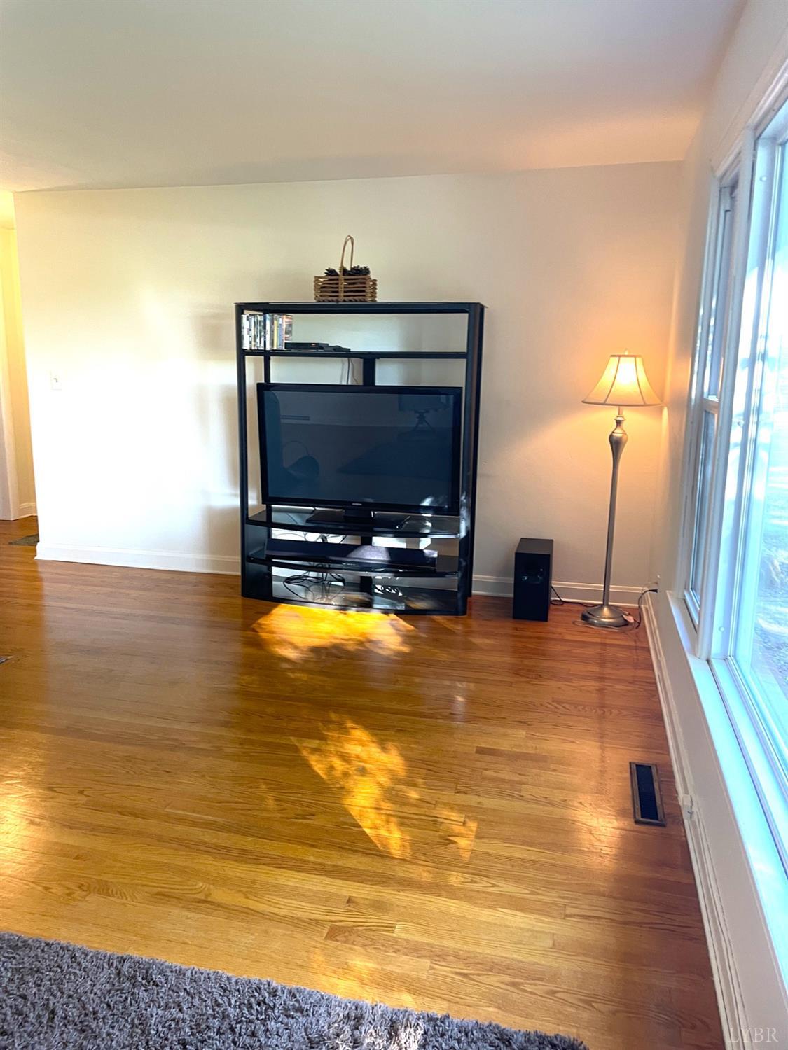 6181 Renan Road Hurt, VA 24563 - Photo 12 of 35 a living room with a flat screen tv and a couch