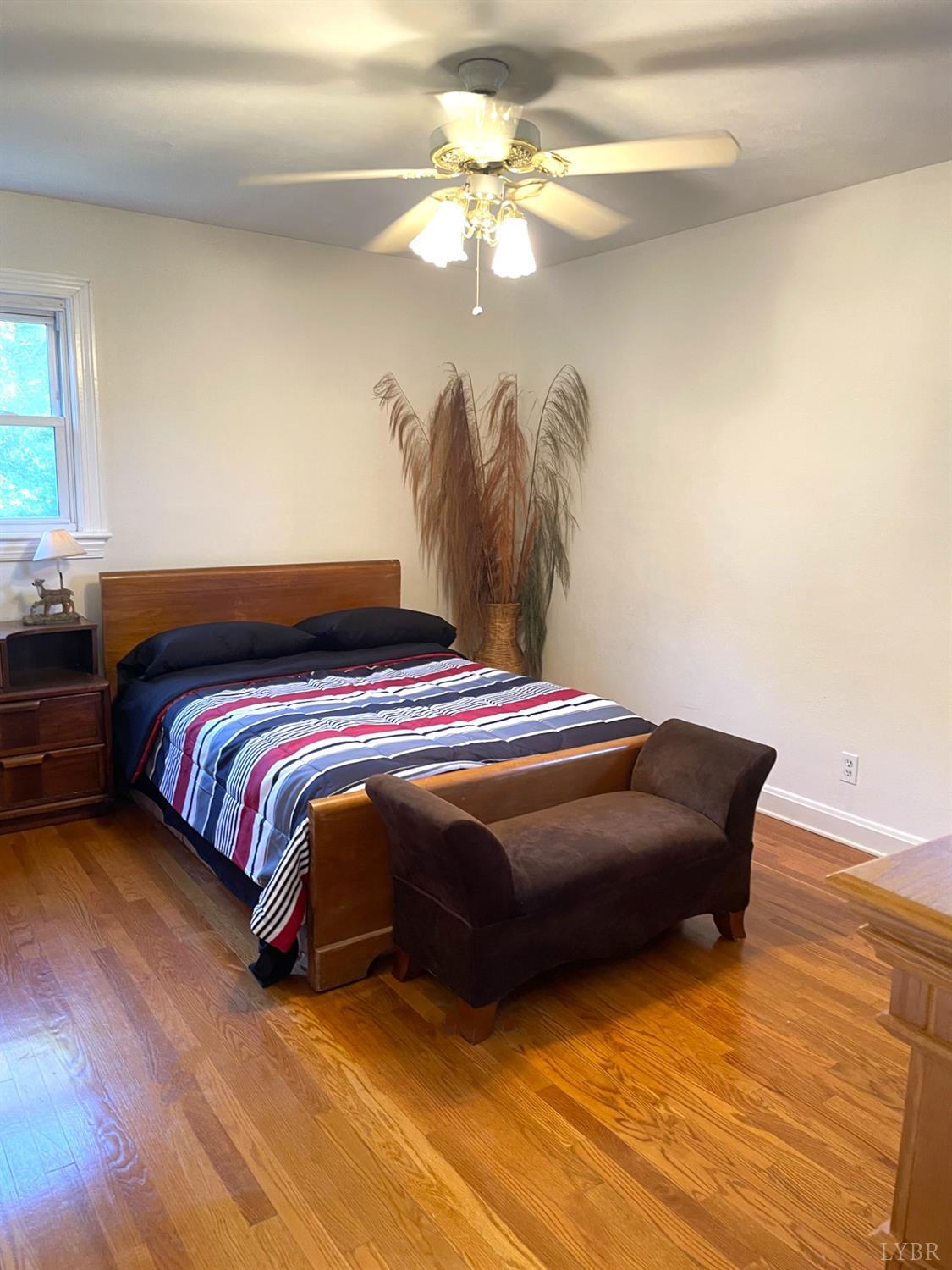 6181 Renan Road Hurt, VA 24563 - Photo 21 of 35 a bedroom with a bed and a chandelier