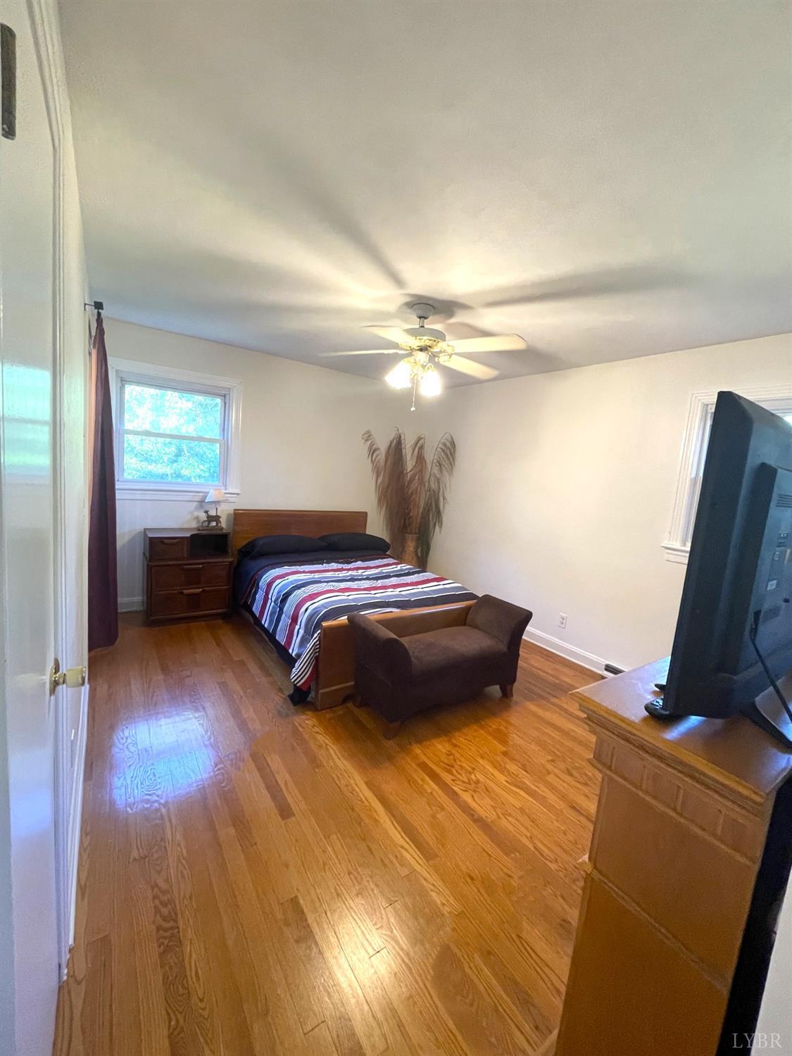 6181 Renan Road Hurt, VA 24563 - Photo 23 of 35 a bedroom with a bed and wooden floor