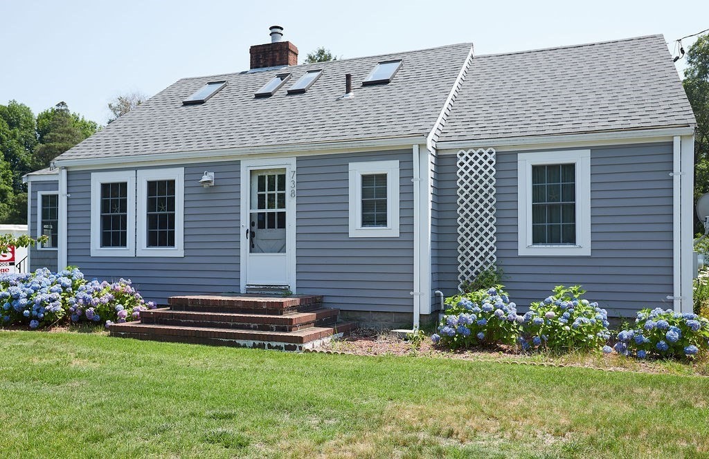 738 Sandwich Road Bourne, MA 02532 - Photo 1 of 25 a front view of a house with a yard