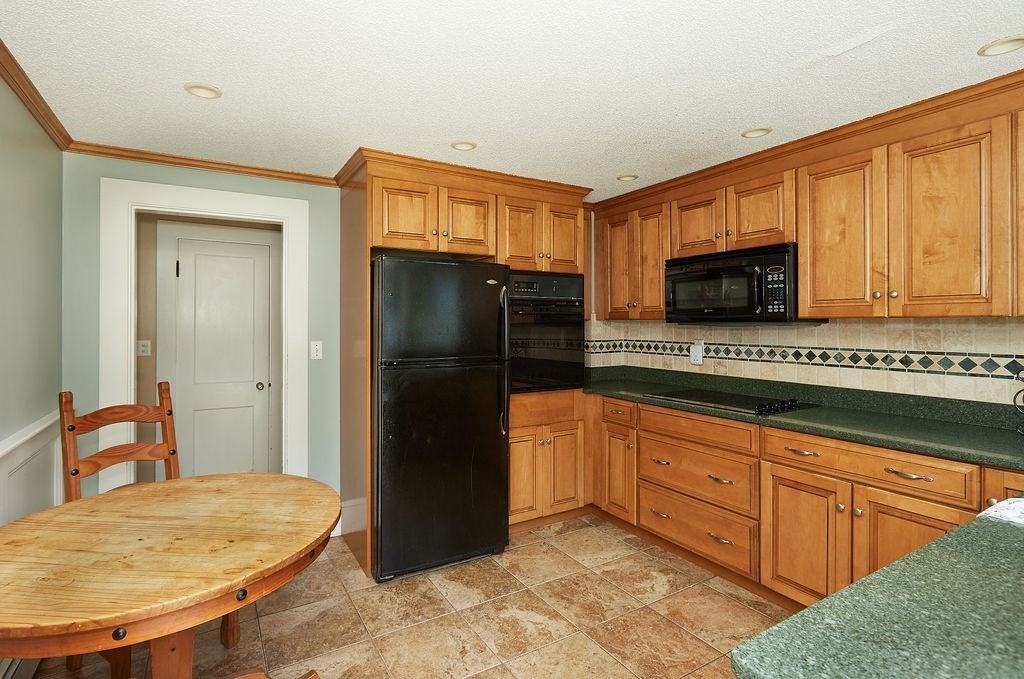738 Sandwich Road Bourne, MA 02532 - Photo 13 of 25 a kitchen with stainless steel appliances granite countertop a refrigerator a stove a sink and dishwasher