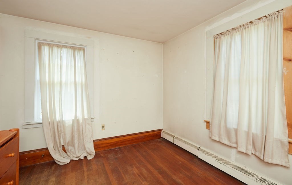 738 Sandwich Road Bourne, MA 02532 - Photo 15 of 25 an empty room with wooden floor and windows