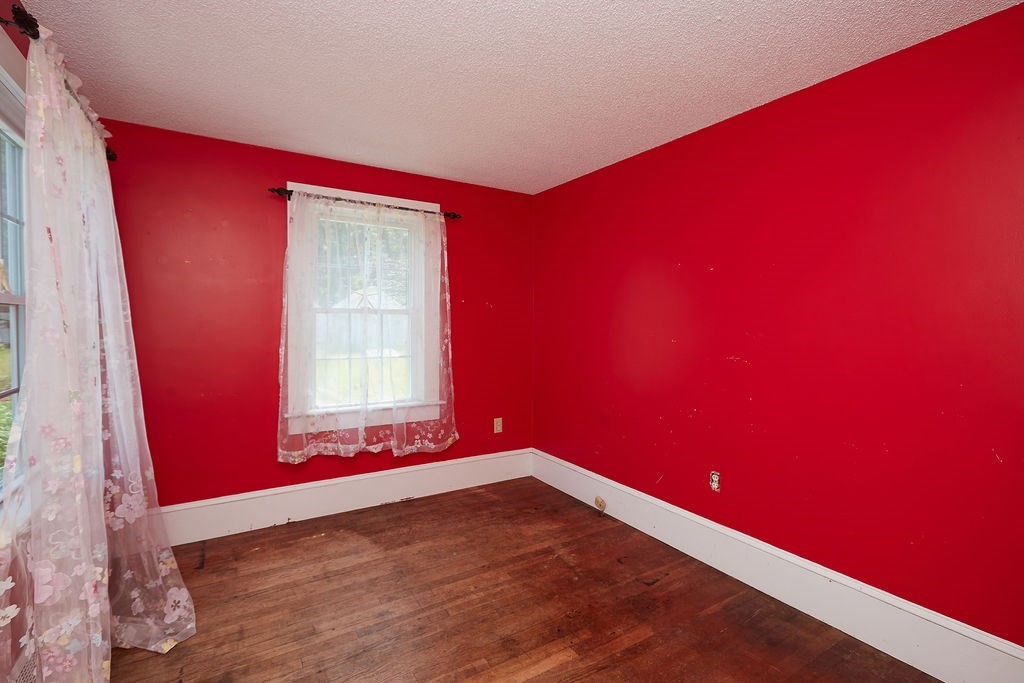 738 Sandwich Road Bourne, MA 02532 - Photo 16 of 25 a view of empty room with wooden floor and fan