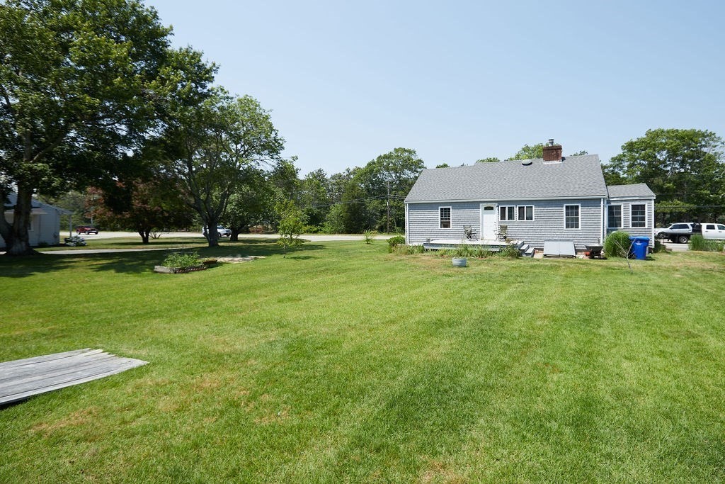 738 Sandwich Road Bourne, MA 02532 - Photo 18 of 25 a front view of a house with a yard and trees