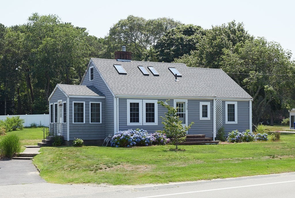 738 Sandwich Road Bourne, MA 02532 - Photo 2 of 25 a view of a house with a yard potted plants and large tree