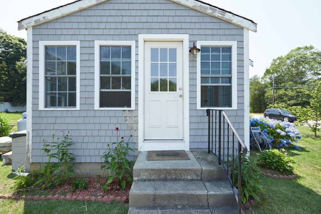 738 Sandwich Road Bourne, MA 02532 - Photo 8 of 25 a front view of a house with a garden