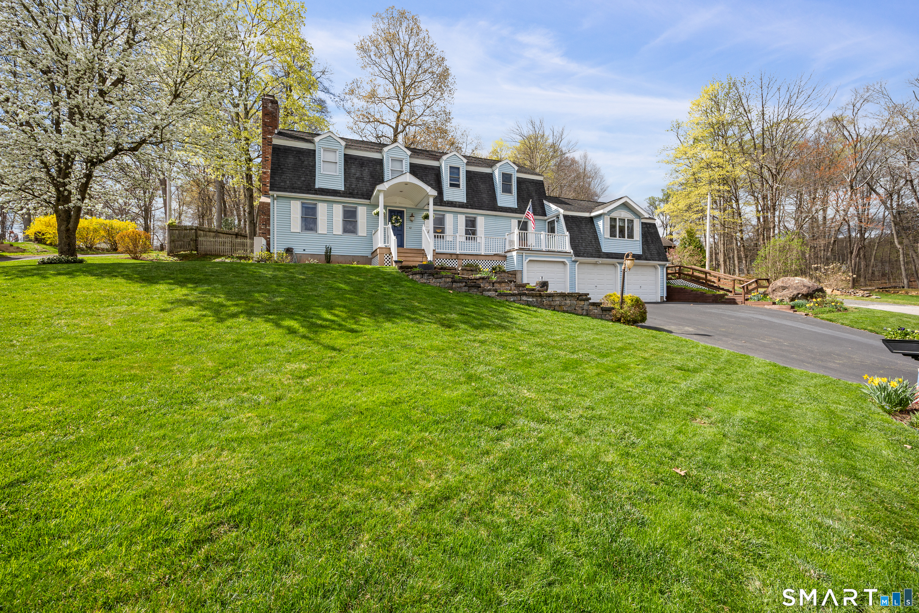 42 Chimney Sweep Road Wallingford, CT 06492 - Photo 4 of 40 a front view of a house with garden and trees