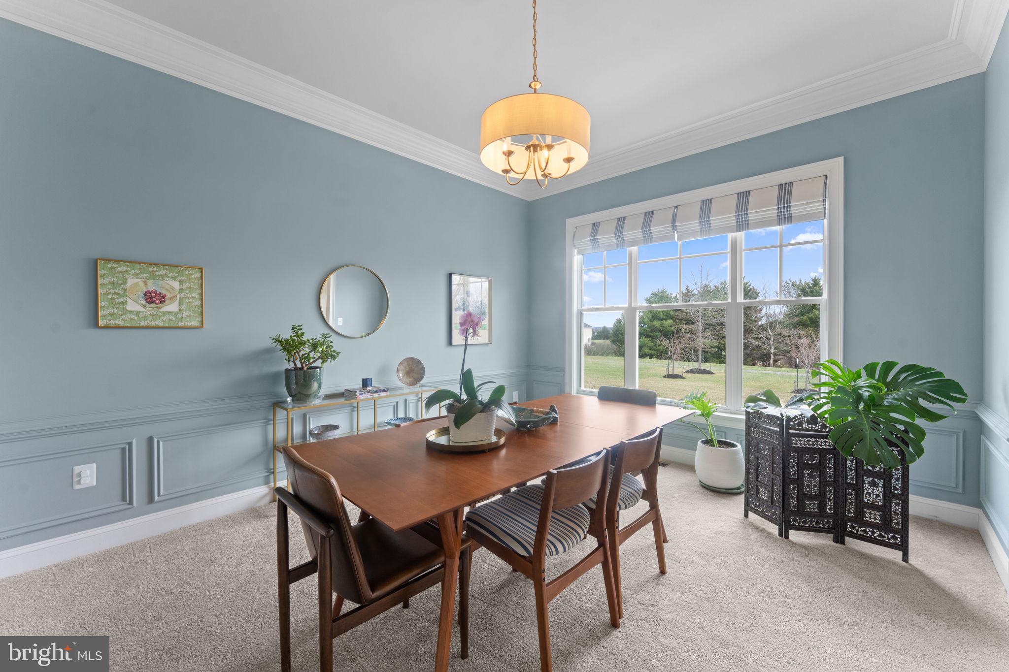 16756 Misty Ridge Lane Purcellville, VA 20132 - Photo 14 of 92 a dining room with furniture a large window and a chandelier