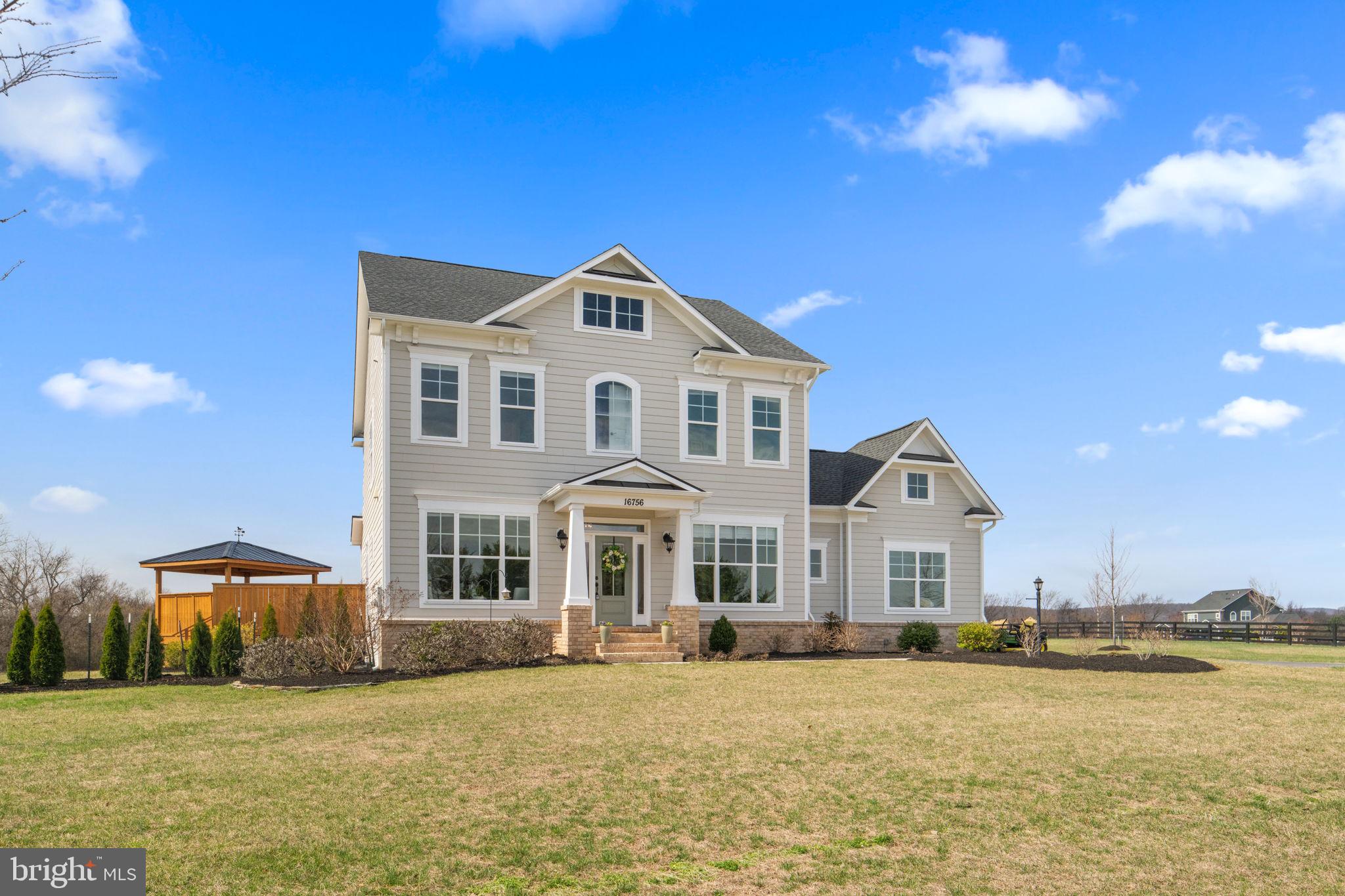 16756 Misty Ridge Lane Purcellville, VA 20132 - Photo 2 of 92 a front view of a house with a garden