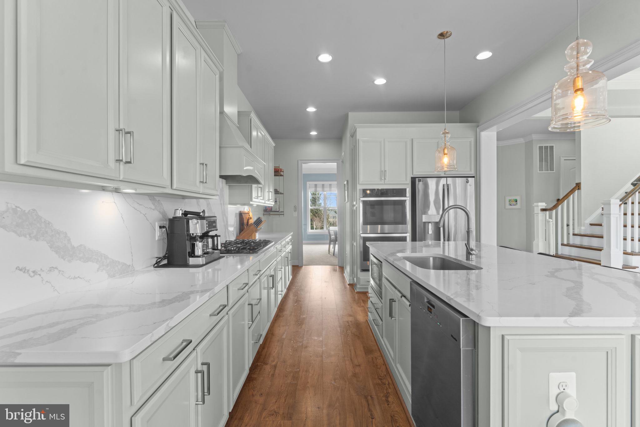 16756 Misty Ridge Lane Purcellville, VA 20132 - Photo 28 of 92 a kitchen with stainless steel appliances granite countertop a sink stove and refrigerator