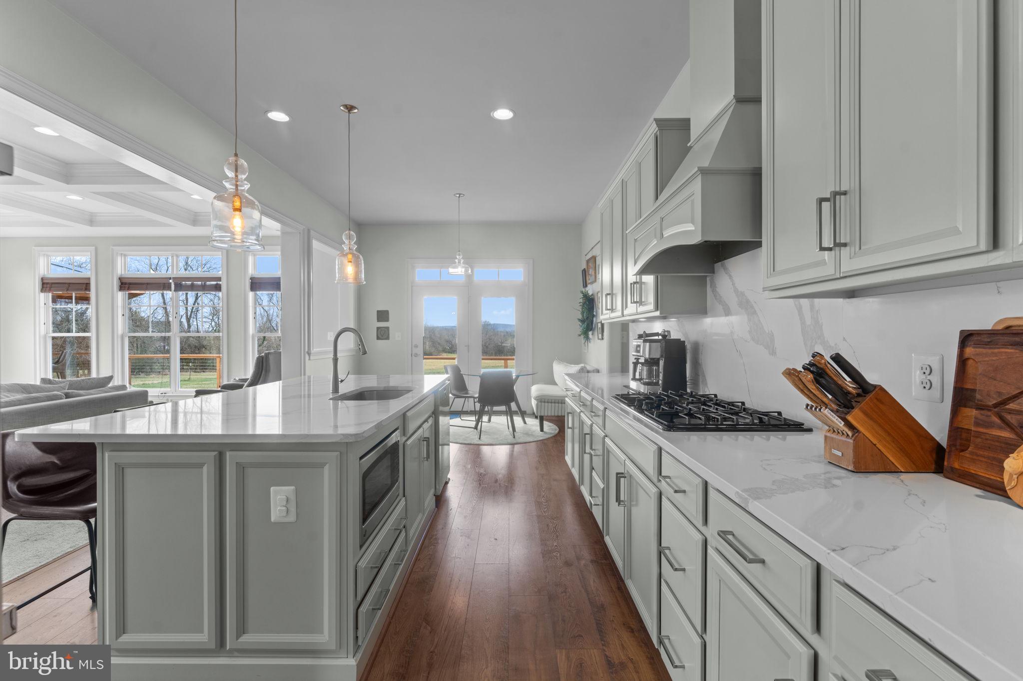 16756 Misty Ridge Lane Purcellville, VA 20132 - Photo 29 of 92 a kitchen with stainless steel appliances granite countertop a sink a stove and a wooden floors